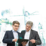 Michael Bozek and Benedikt Rauscher looking together at a tablet