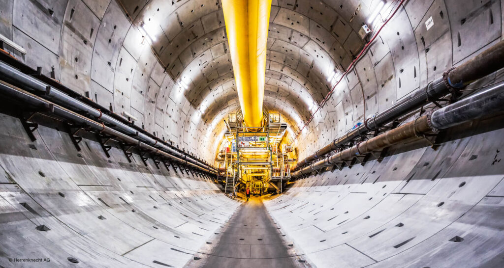 Gigantic tunnel-boring machines are making their way through mountain ranges.