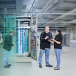 Two people in front of switch cabinet from Pepperl+Fuchs